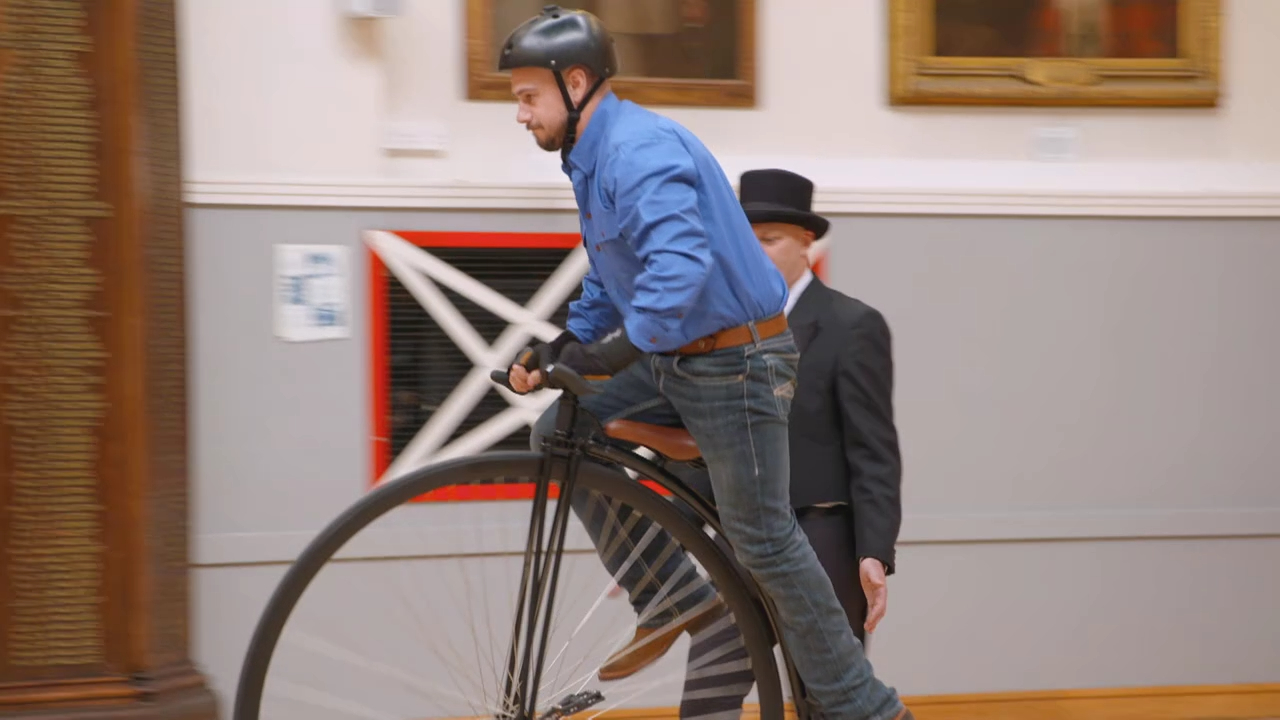 The Guides get a crash course in riding a Penny Farthing